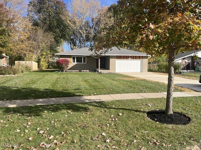 single story home featuring a front lawn and a garage