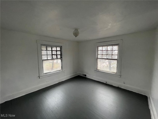 unfurnished room featuring dark hardwood / wood-style flooring