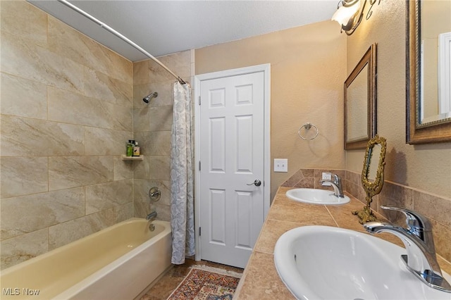 bathroom with shower / tub combo with curtain and a sink