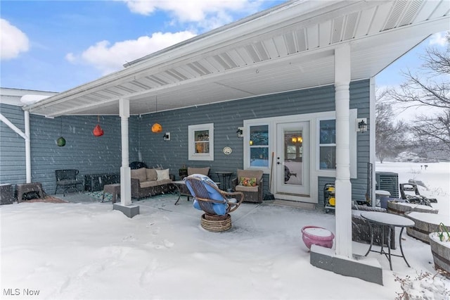 snow covered patio with outdoor lounge area