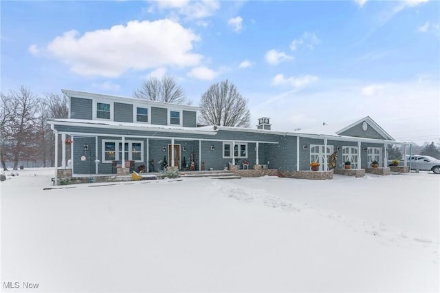 snow covered house with a porch