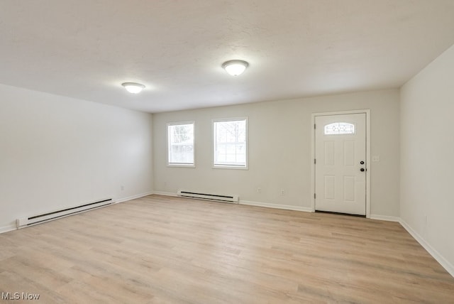 foyer with a baseboard heating unit and light hardwood / wood-style flooring