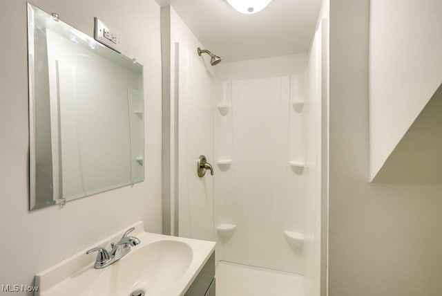 bathroom with vanity and walk in shower