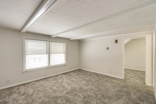 carpeted spare room with a textured ceiling and beamed ceiling