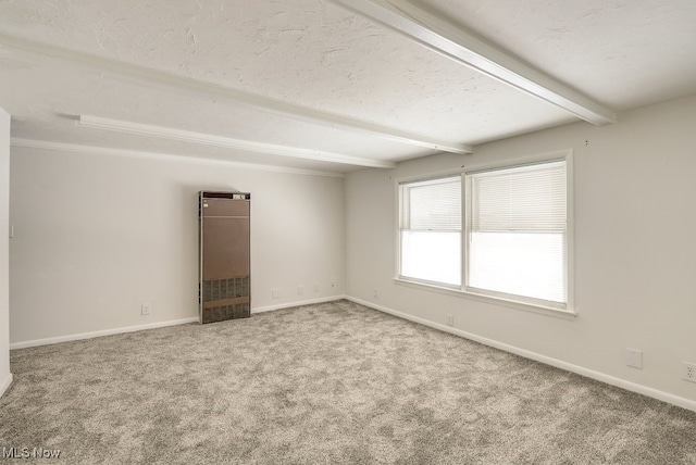 empty room with a textured ceiling, carpet floors, and beamed ceiling