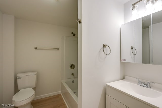 full bathroom featuring toilet, vanity, hardwood / wood-style flooring, and washtub / shower combination