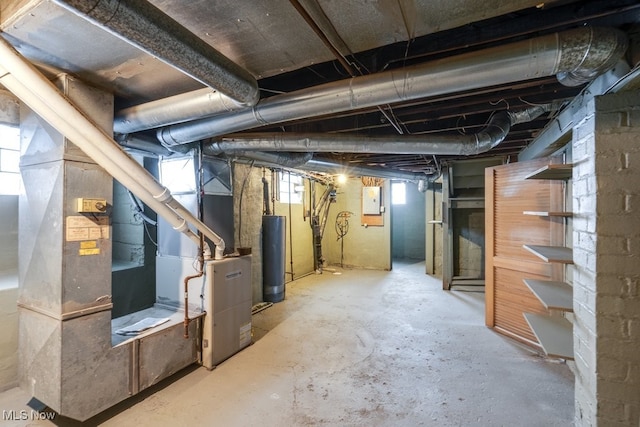 basement featuring electric panel and water heater