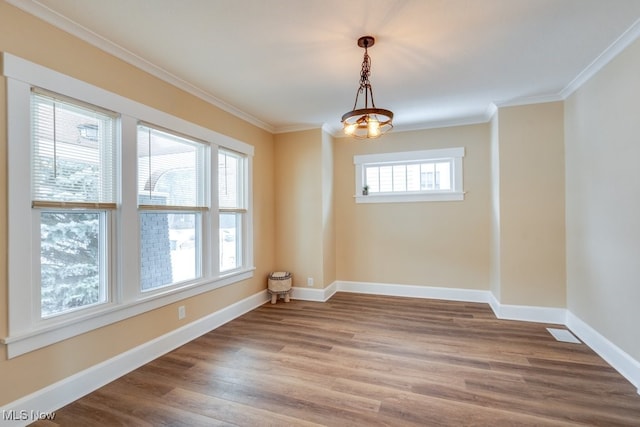 unfurnished room featuring crown molding and wood-type flooring