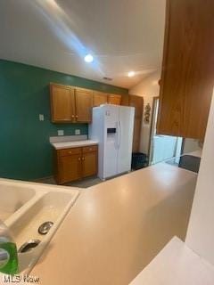 kitchen with white refrigerator with ice dispenser