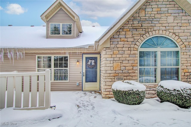 view of snow covered property entrance