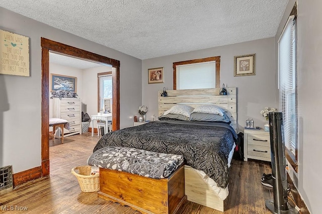 bedroom featuring wood-type flooring and a textured ceiling