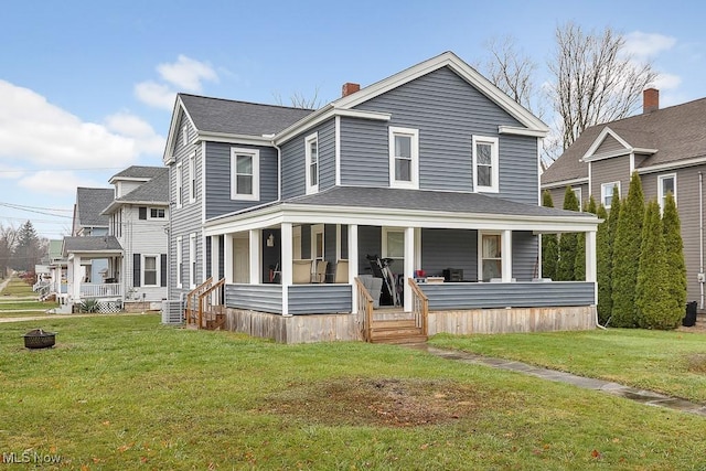 view of front facade with central AC unit, covered porch, and a front lawn