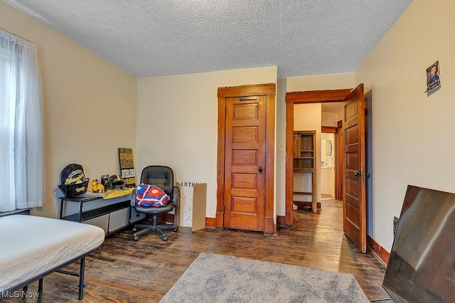 office area featuring a textured ceiling and dark hardwood / wood-style floors