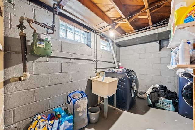 basement featuring separate washer and dryer and sink