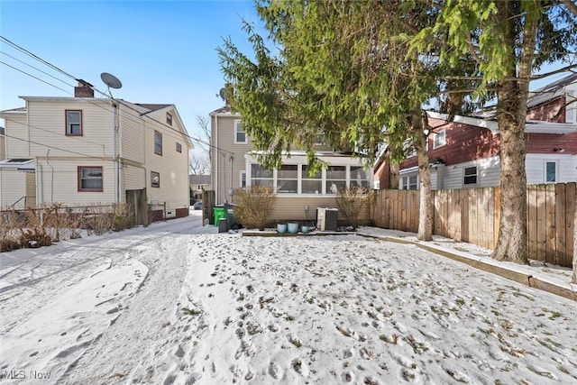 yard layered in snow with central AC unit