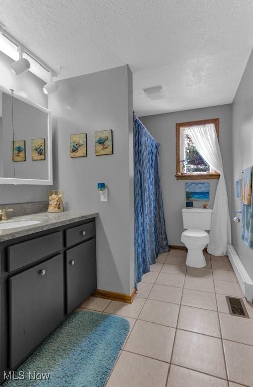 bathroom with toilet, tile patterned flooring, a textured ceiling, and vanity