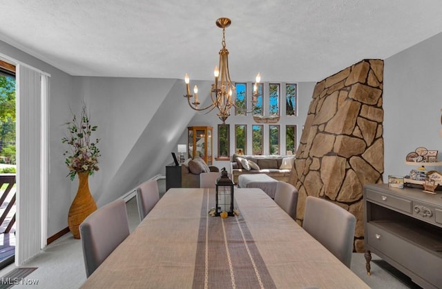 dining room featuring a textured ceiling, light colored carpet, and a chandelier