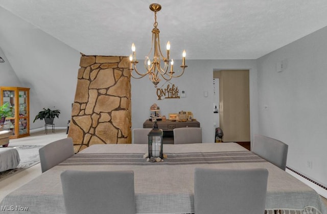 dining area with a textured ceiling, baseboard heating, and an inviting chandelier