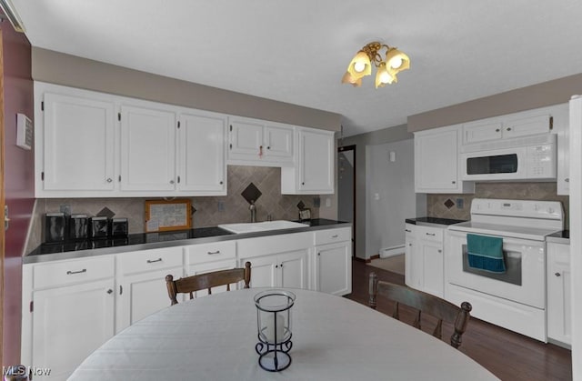 kitchen with white appliances, white cabinets, decorative backsplash, and sink