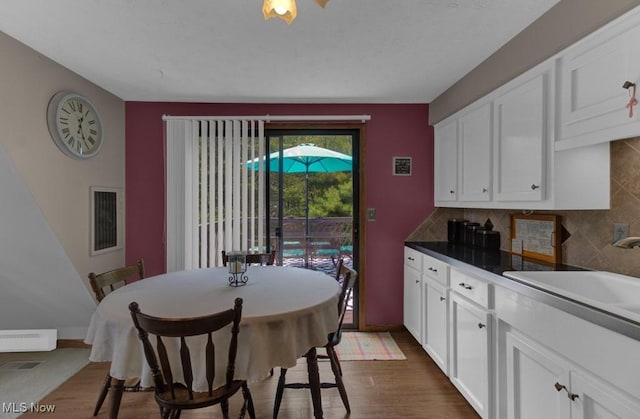 dining area featuring sink and dark hardwood / wood-style floors