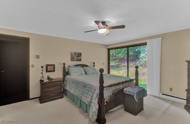 carpeted bedroom with ceiling fan, a baseboard radiator, and access to exterior