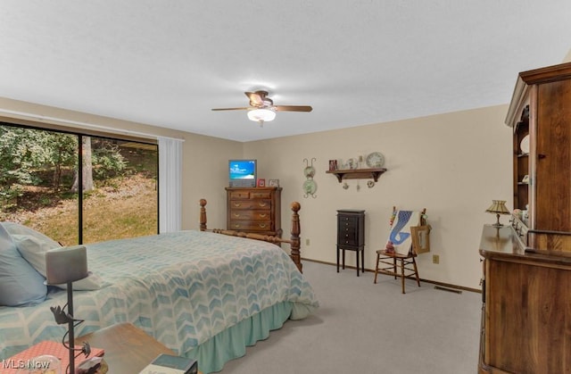 bedroom featuring ceiling fan, light colored carpet, and access to exterior