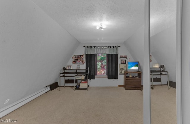 interior space with baseboard heating, a textured ceiling, and carpet flooring