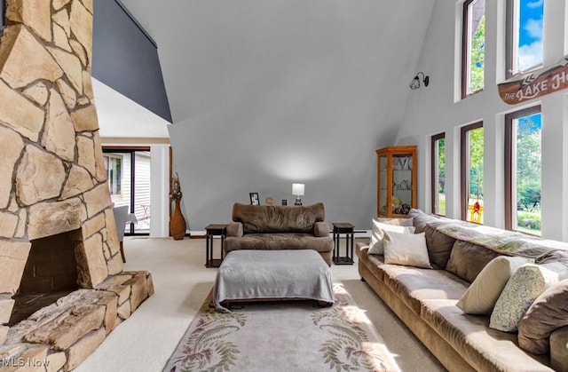 carpeted living room with a high ceiling and a fireplace