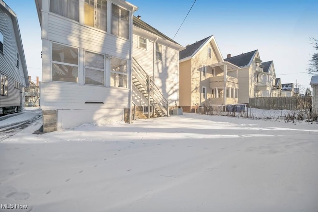 view of snow covered rear of property