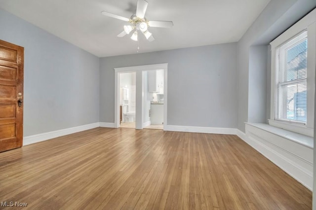 spare room featuring ceiling fan and light hardwood / wood-style flooring