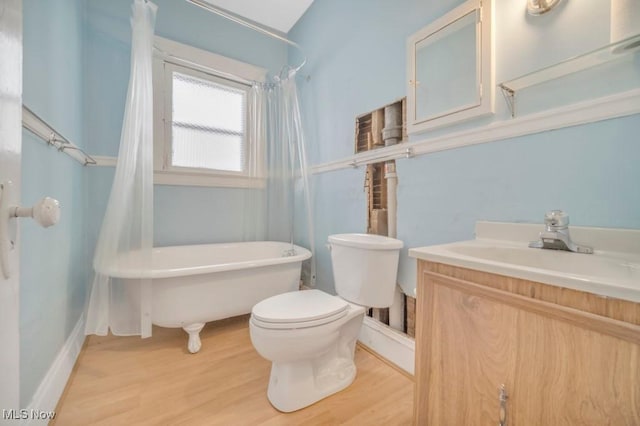 full bathroom featuring toilet, shower / tub combo with curtain, wood-type flooring, and vanity