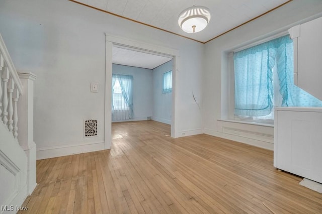 empty room featuring washer / clothes dryer and light hardwood / wood-style floors