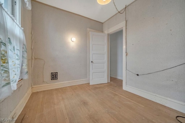 spare room with wood-type flooring