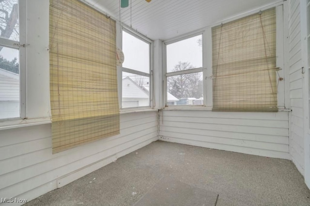 unfurnished sunroom with ceiling fan and a healthy amount of sunlight