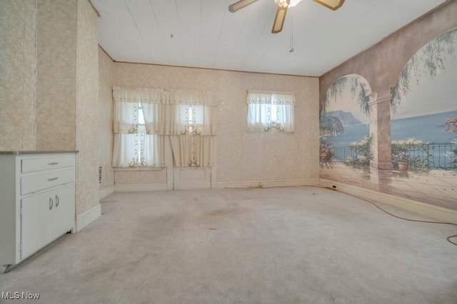 empty room featuring light carpet and ceiling fan