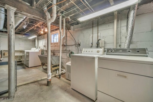 clothes washing area featuring separate washer and dryer