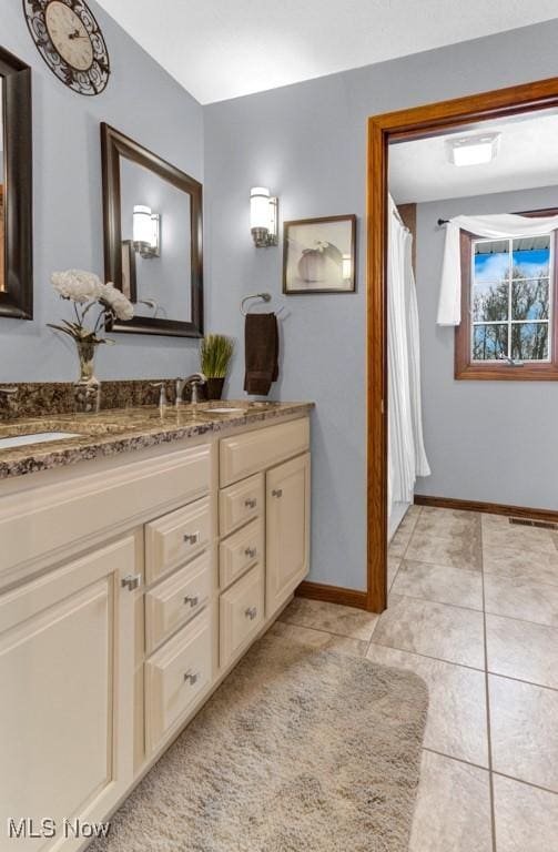 bathroom with vanity and tile patterned flooring