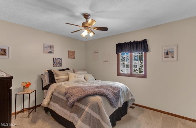 bedroom featuring light carpet and ceiling fan