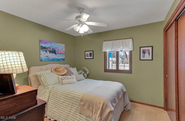 bedroom featuring ceiling fan, a closet, and light carpet