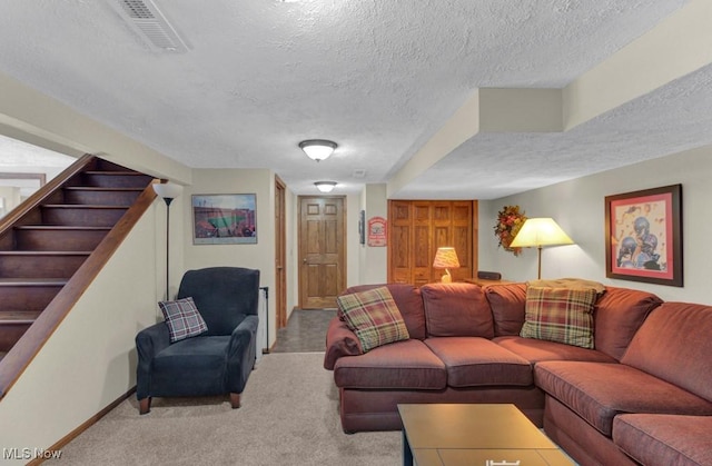 carpeted living room featuring a textured ceiling