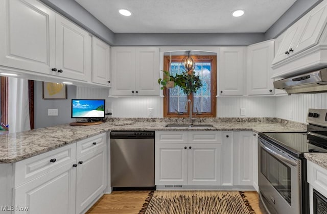 kitchen with white cabinetry, stainless steel appliances, and sink