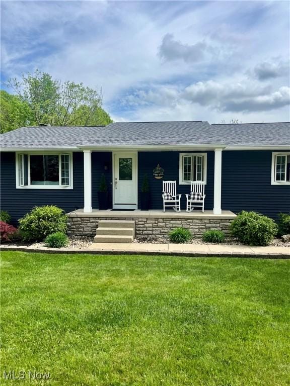 ranch-style home featuring a porch and a front lawn