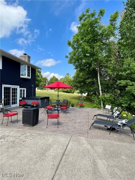 view of patio / terrace featuring a jacuzzi