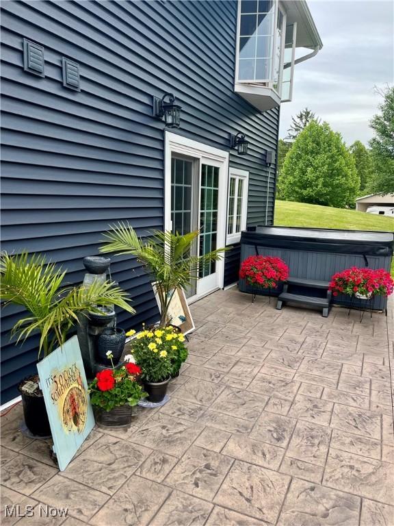 view of patio / terrace with a hot tub and french doors