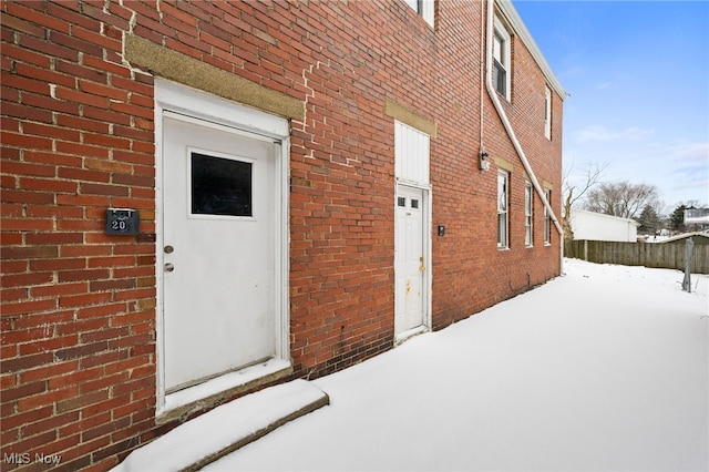 view of snow covered property entrance