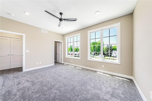 unfurnished bedroom featuring a closet, ceiling fan, and carpet