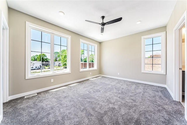 spare room with carpet floors and ceiling fan