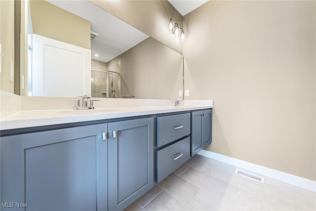 bathroom featuring an enclosed shower, vanity, and tile patterned flooring