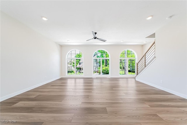 unfurnished living room featuring light wood-type flooring and ceiling fan