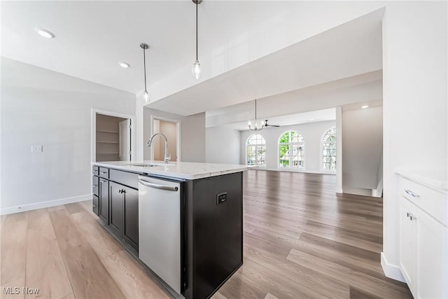 kitchen with sink, stainless steel dishwasher, a kitchen island with sink, and hanging light fixtures